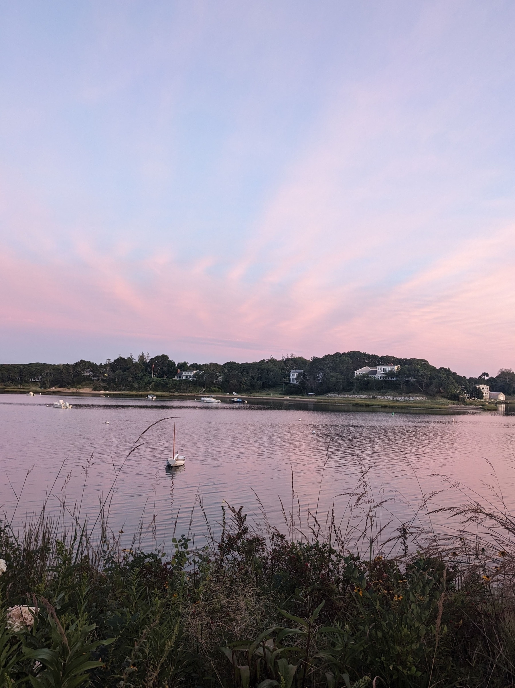 Cape Cod sunset over a cove with subtle pink and blue skies.