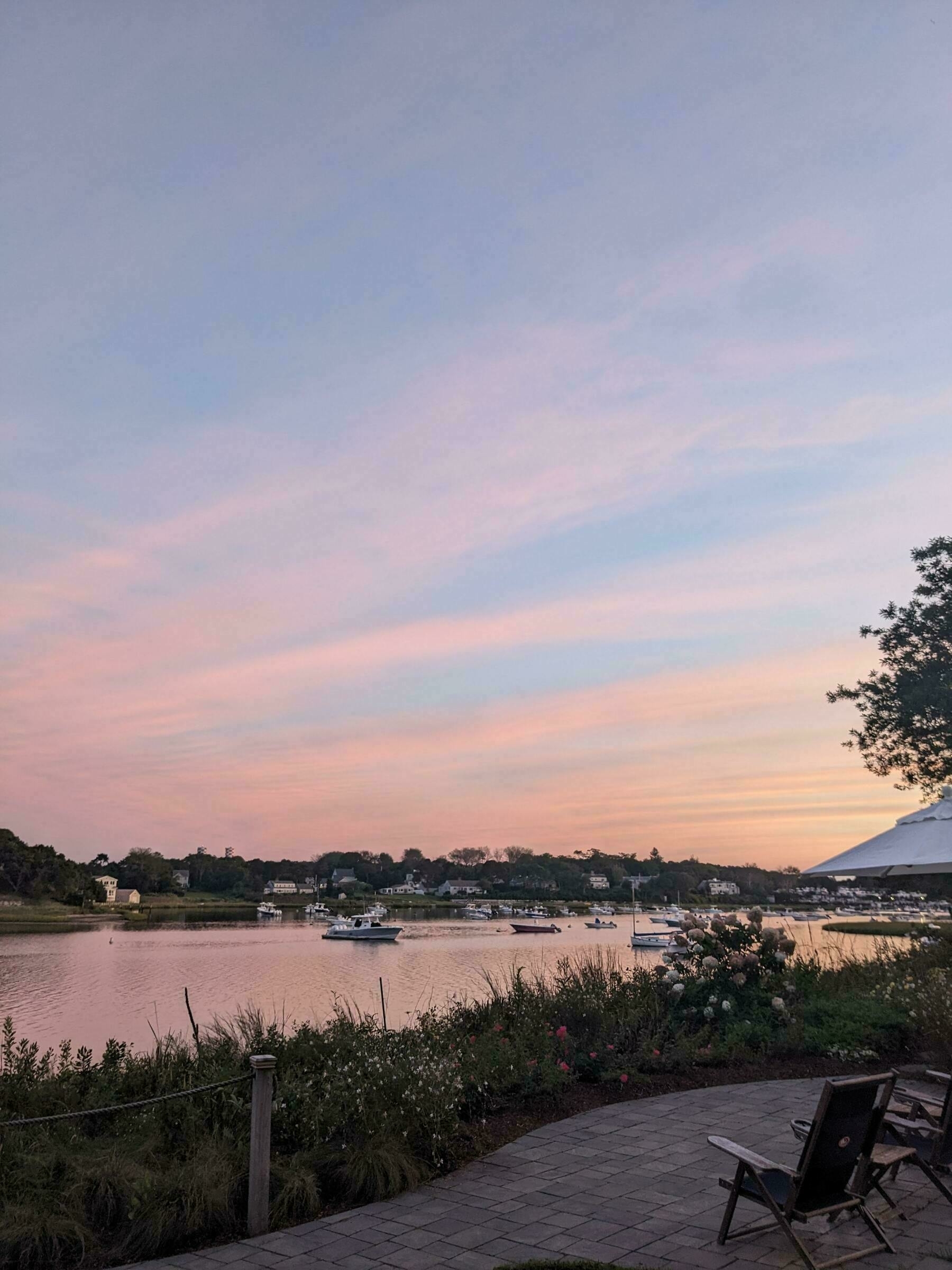 Cape Cod sunset over a cove with subtle pink and blue skies.