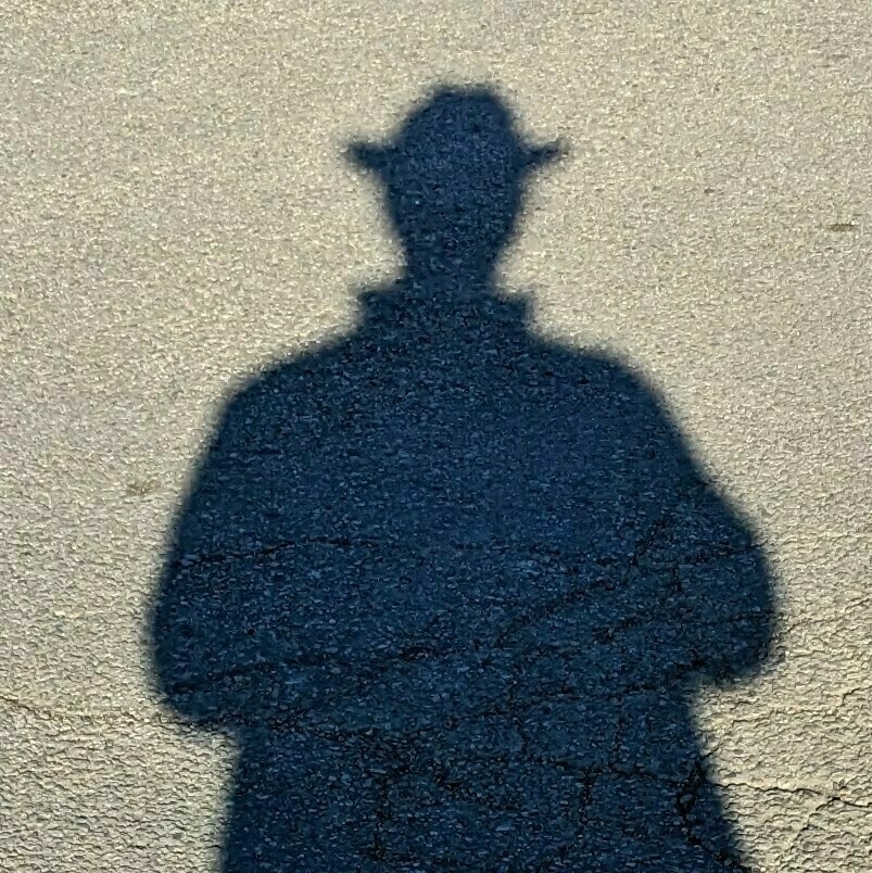 Shadow silhouette of a person wearing a cowboy hat