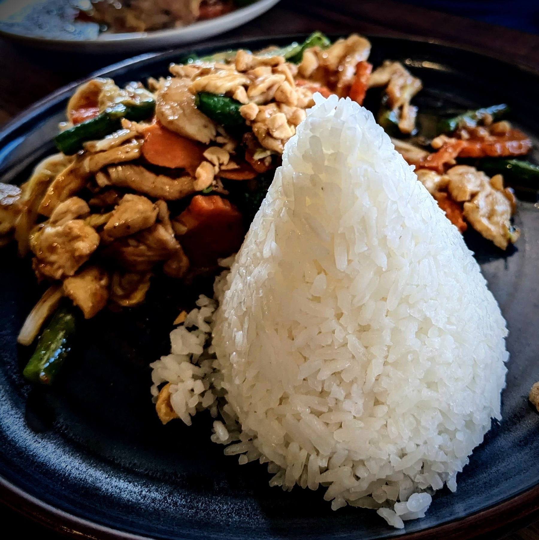 plate of Thai food featuring a pyramid of rice
